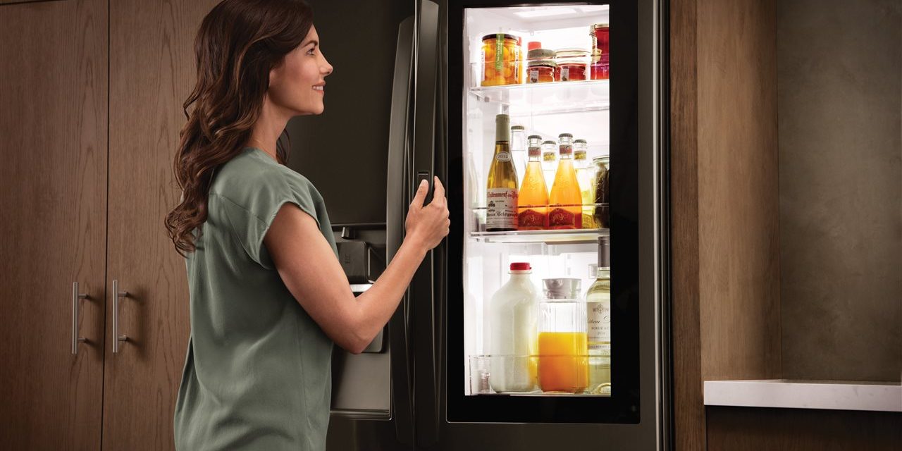 a woman opening a fridge | AHI Residential | kitchen Charlotte a woman opening a fridge | AHI Residential | kitchen Charlotte