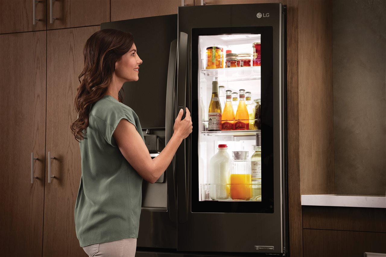 a woman opening a fridge | AHI Residential | kitchen Charlotte a woman opening a fridge | AHI Residential | kitchen Charlotte