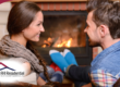 Happy couple sitting by a warm fireplace, enjoying a cozy moment together, representing comfort and relaxation in a home setting.