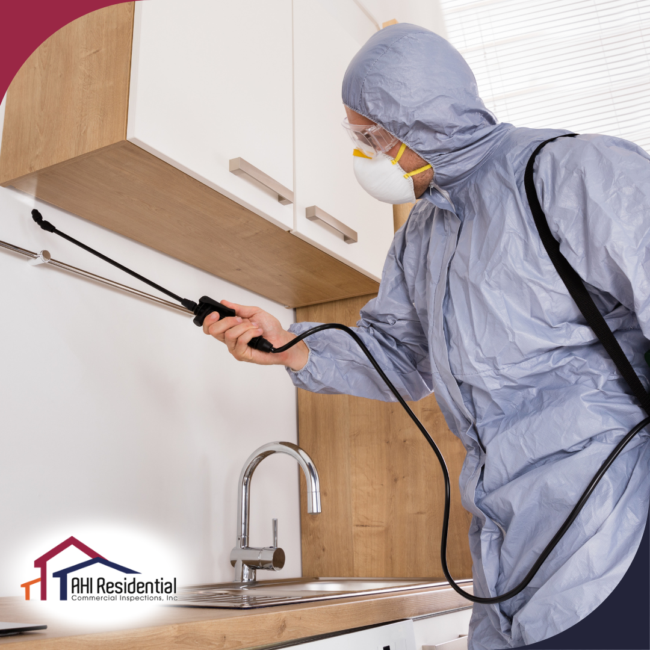 AHI Residential & Commercial Inspections (8) Professional home inspector in protective gear conducting a pest control inspection in a modern kitchen