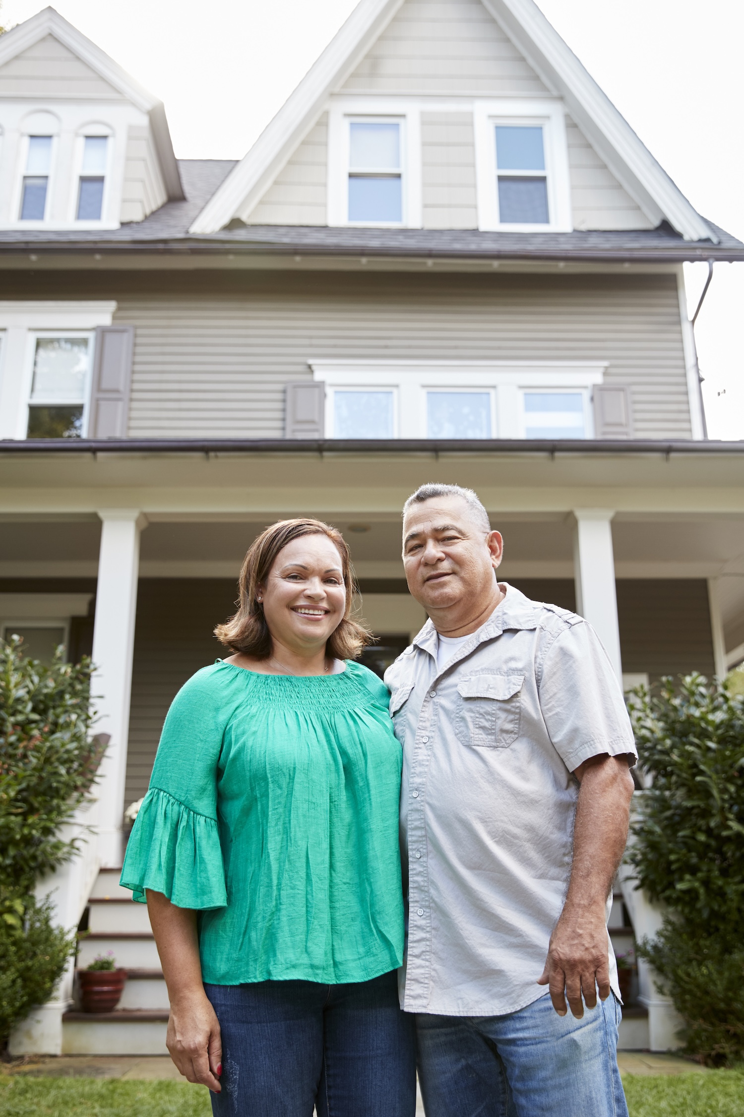 Portrait Of Smiling Couple In Front Of Their Home getting a Home Inspection Statesville NC