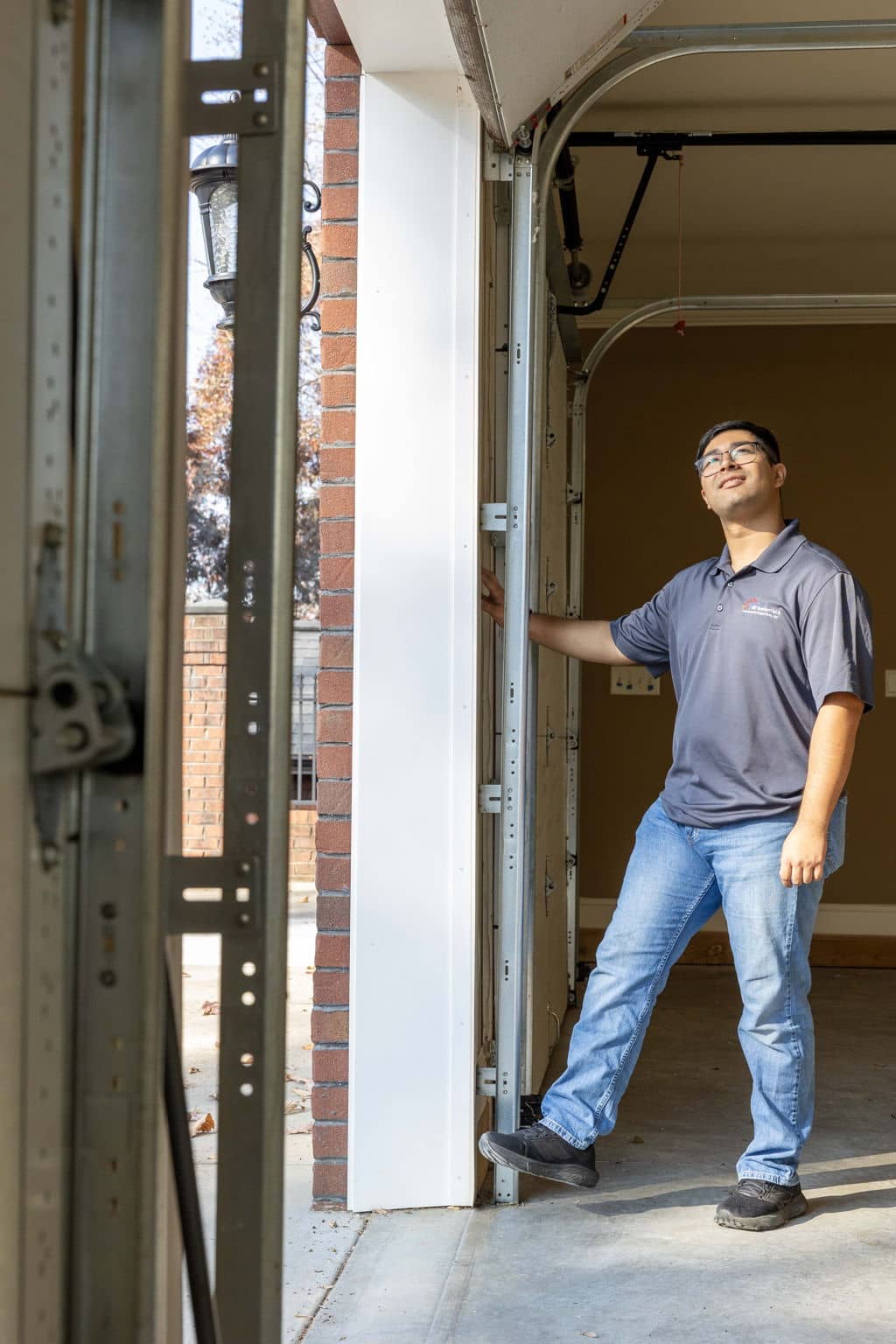 home inspector testing a garage door's safety features with his foot