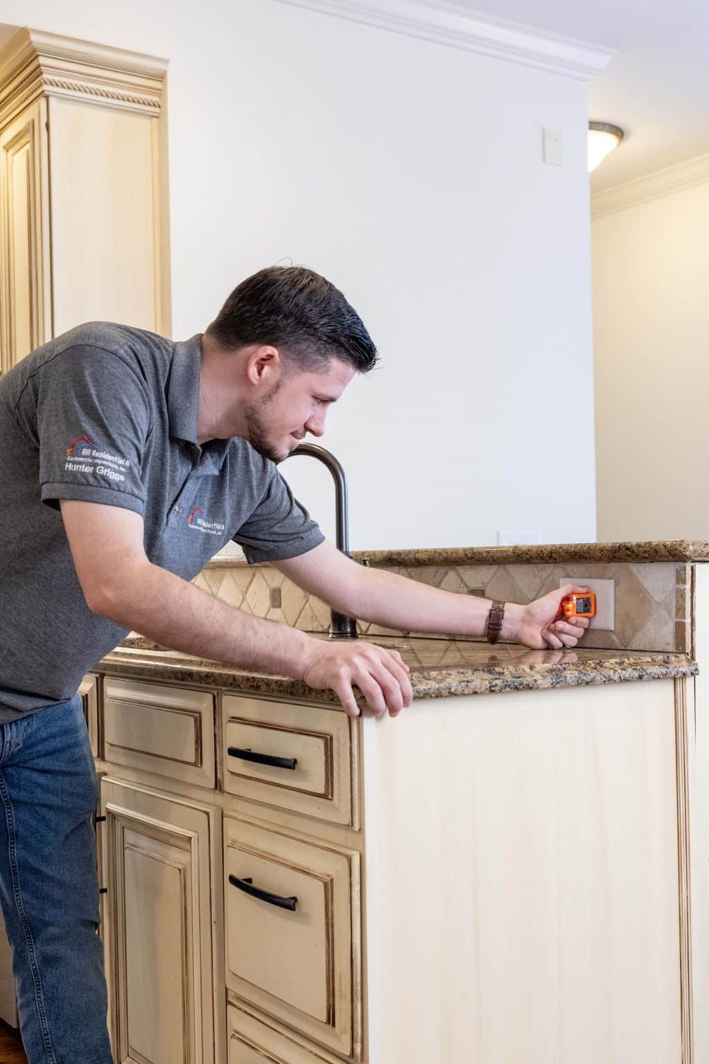 home inspector testing a gfci outlet in the kitchen to see if it is properly installed