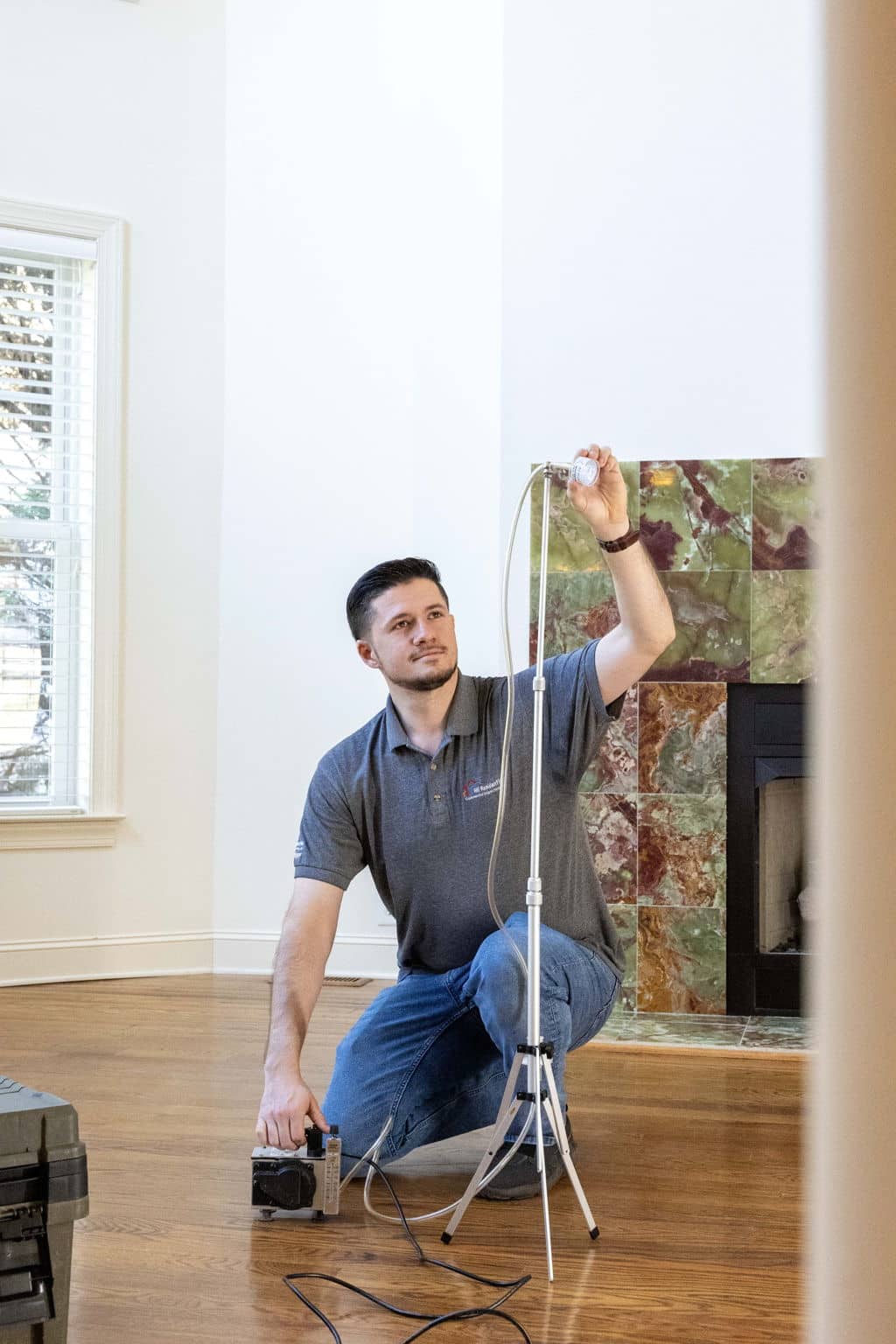 a home inspector performing a mold/indoor air quality test using a mold pump