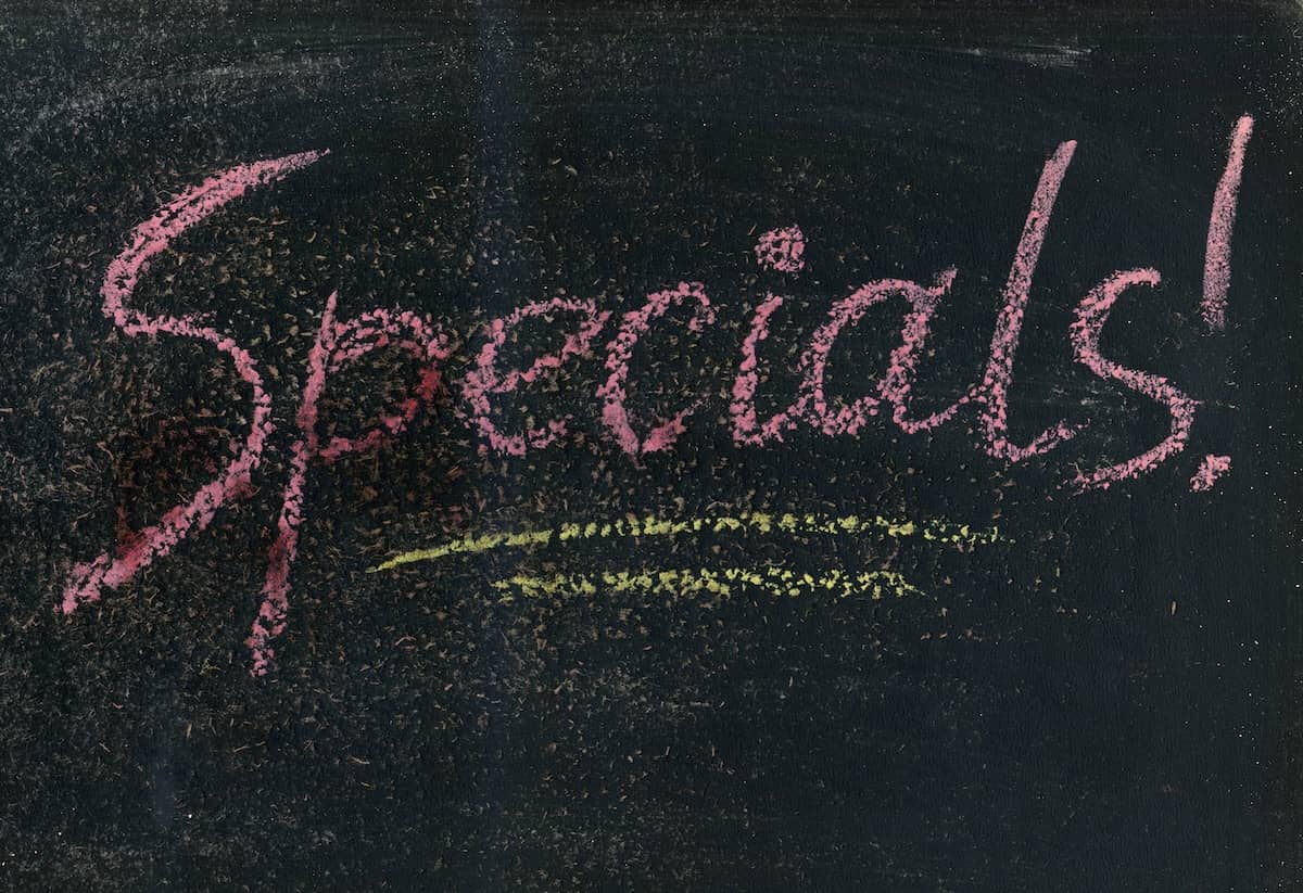 Specials written on a chalkboard with chalk to represent promos