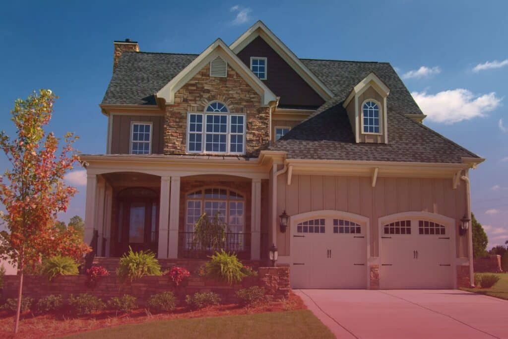 Exterior of a two-story stone and siding residential home evaluated during a professional home inspection for potential defects.