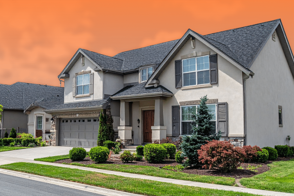 Front exterior of a two-story suburban home featuring dark shutters, a two-car garage, and a landscaped yard under an orange sky.