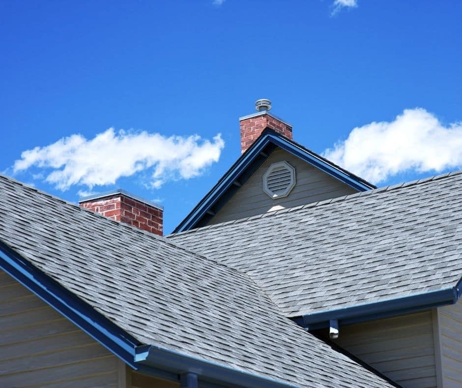 Prep Checklist: Get a Home Inspection When Buying a House 3 Close-up of damaged asphalt roof shingles found during a home inspection when buying a house, showing a potential source of leaks.