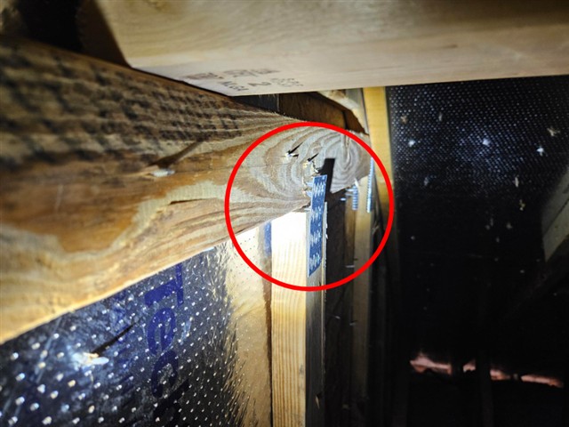 Damaged truss end at a gusset plate in the attic of Home B