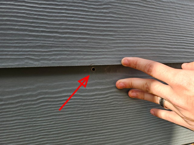 Overdriven nail breaking the face of fiber cement siding on Home B