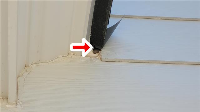 Fiber cement siding improperly cut and installed at a roof kickout on Home G