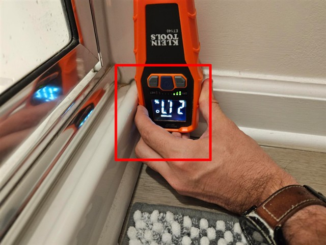 Moisture meter reading taken at the baseboard next to the shower in Home A