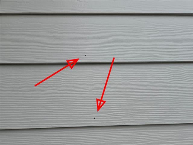 Overdriven nails in fiber cement siding on Home E
