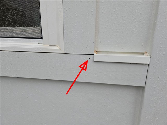 Open, unsealed joint in the trim below a window on Home C