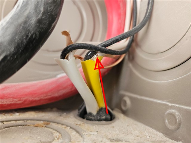 Close-up of a neutral wire in the Home D main panel with damaged insulation and exposed copper