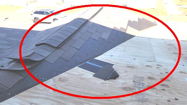 Missing shingles exposing bare roof plywood on Home H