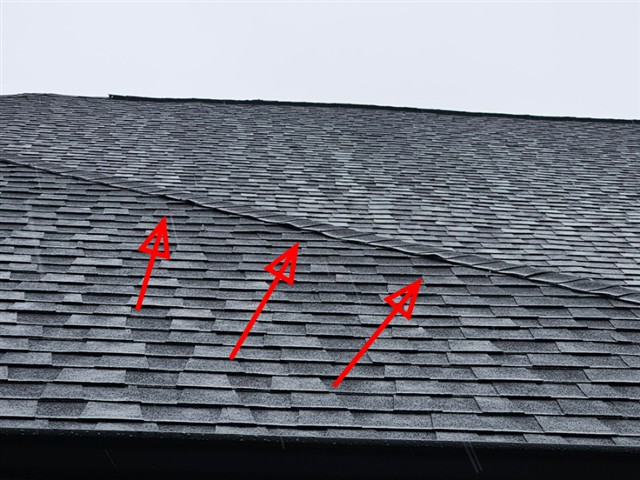 Shingles beginning to lift along a roof valley on Home C