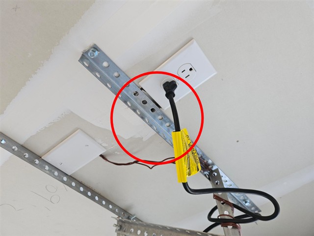 Fire separation breached between the electrical outlet and garage door opener brackets in Home A