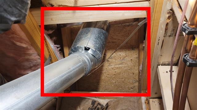 Attic area in Home H with batt insulation missing and framing exposed