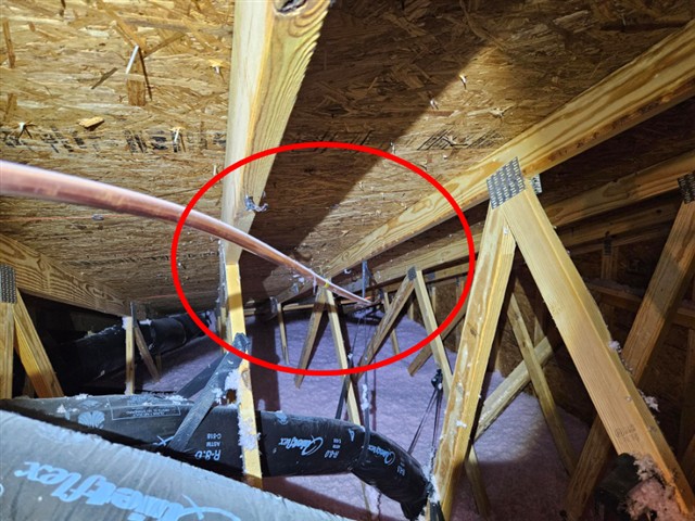 Copper gas line in the attic of Home A not set into its supports