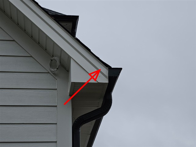Metal fascia wrap cut short at a gable corner on Home C