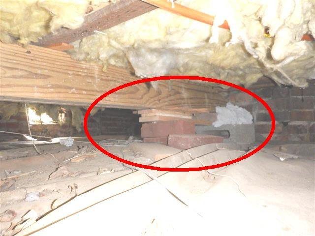 Home D: dry-stacked bricks, with no mortar, holding up an added girder