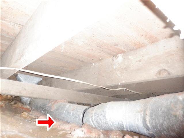 Home C: a rusted supply duct resting on the ground