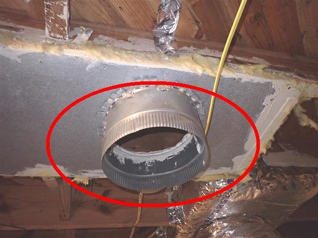 Home E: a supply plenum open to the crawl space where a duct is missing