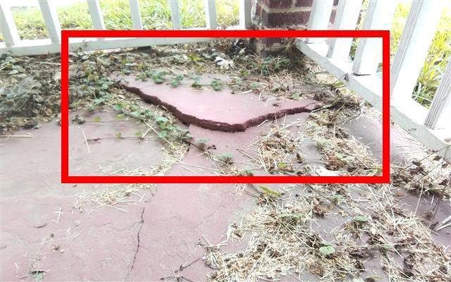 Home C: the front porch slab has dropped and now slopes toward the house