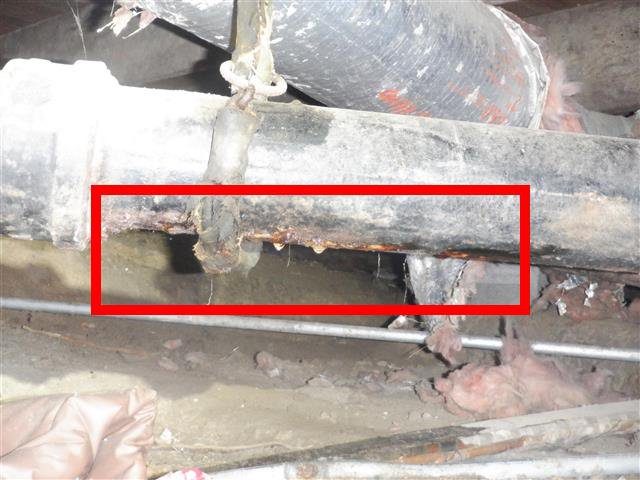 Home C: a PVC waste line badly connected to the cast iron main, with leaks