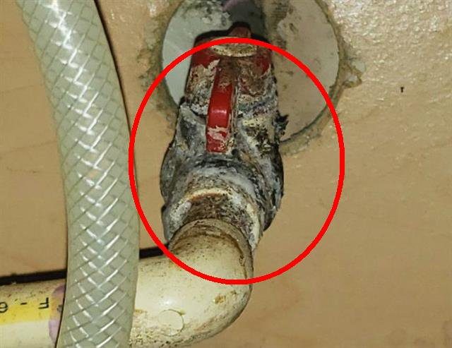 Home F: a leaking shut-off valve that has damaged the cabinet
