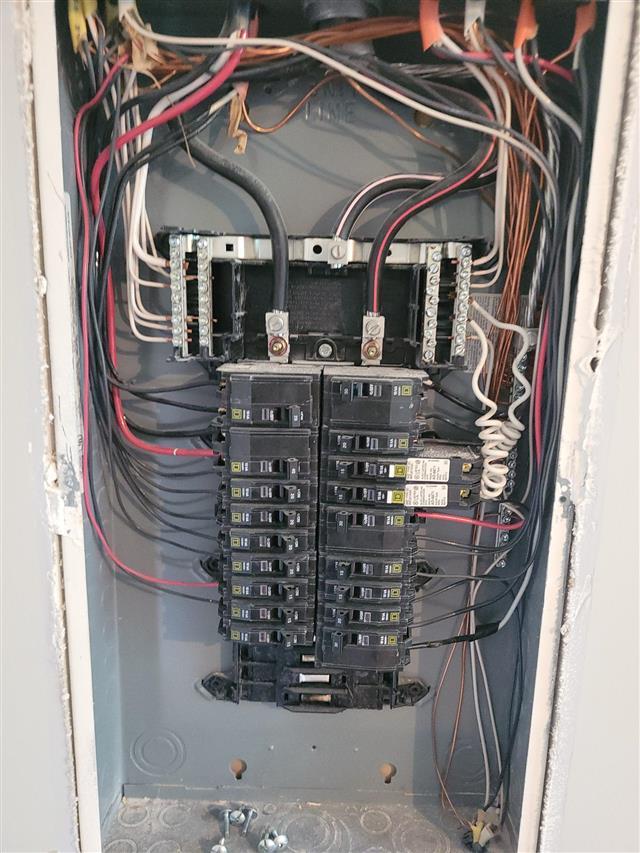 Inside of a residential electrical panel with the cover removed during a condo inspection