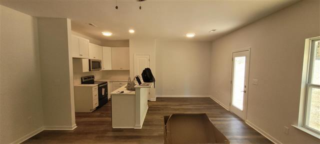 Brand New Doesn't Mean Problem-Free: A Gastonia New Construction Home Inspection 3 New construction kitchen with white cabinets and vinyl plank flooring in a Gastonia home